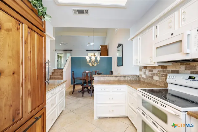 a kitchen with stainless steel appliances granite countertop a sink and cabinets