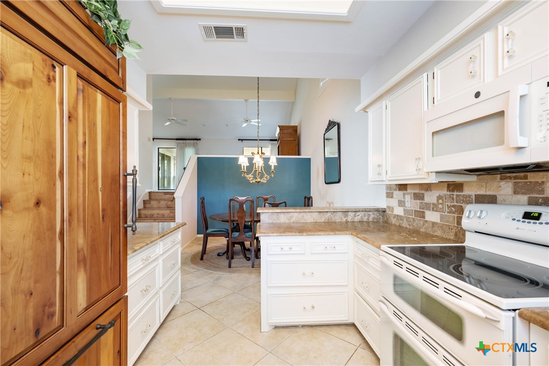 5 Cypress Point Wimberley, TX 78676 - Photo 14 of 33 a kitchen with stainless steel appliances granite countertop a sink and cabinets