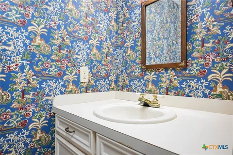 a bathroom with a sink and a mirror