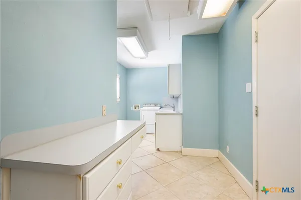 a room with a sink and a mirror