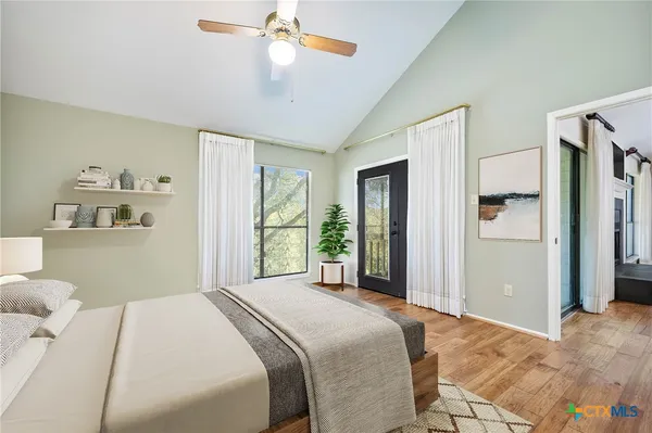 a bedroom with a large bed and a window