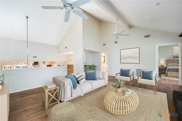 a living room with furniture and a chandelier