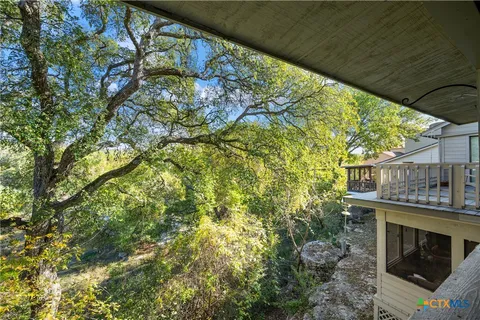 a balcony with fireplace and outdoor seating