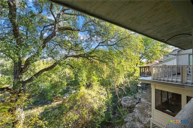 a balcony with fireplace and outdoor seating