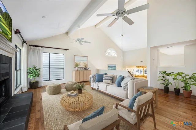 a living room with furniture potted plant and a window