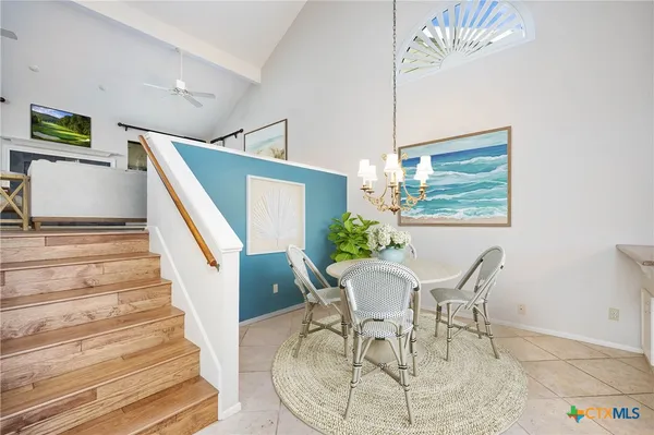 a view of a dining room with furniture a rug and wooden floor