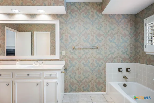 a bathroom with a bathtub and a sink