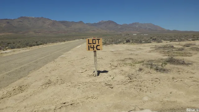 a view of a brick wall and a building