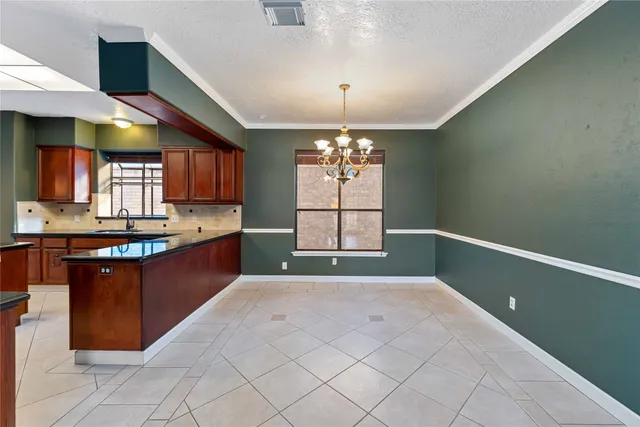 a kitchen with stainless steel appliances granite countertop a stove and a sink