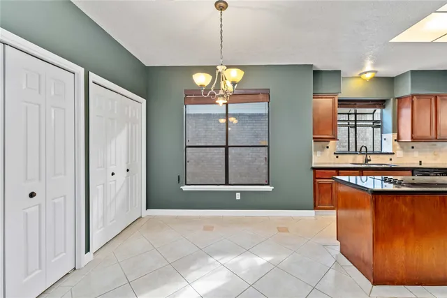 a kitchen with stainless steel appliances granite countertop a sink a stove and a refrigerator