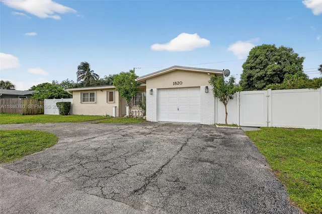 a view of a house with a yard and garage