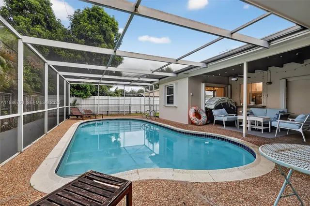 a view of backyard with wooden fence