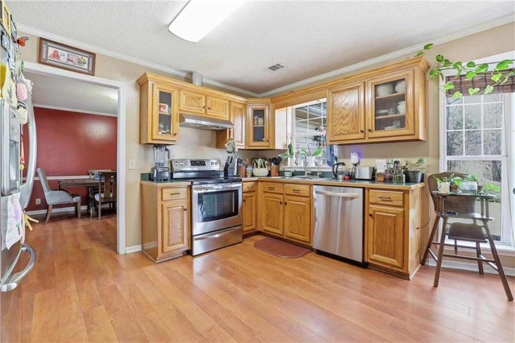 4564 Highway 51 Lula, GA 30554 - Photo 11 of 46 a kitchen with a sink cabinets and wooden floor