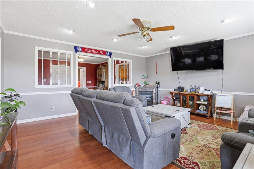 4564 Highway 51 Lula, GA 30554 - Photo 13 of 46 a living room with furniture and a flat screen tv