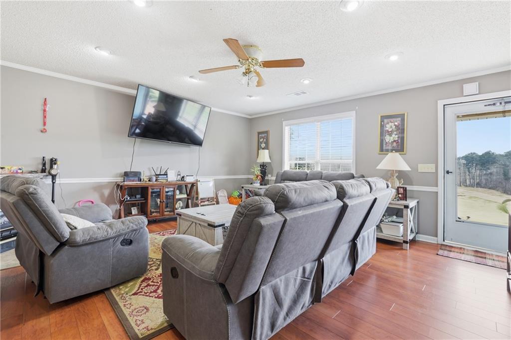 4564 Highway 51 Lula, GA 30554 - Photo 14 of 46 a living room with furniture and a flat screen tv