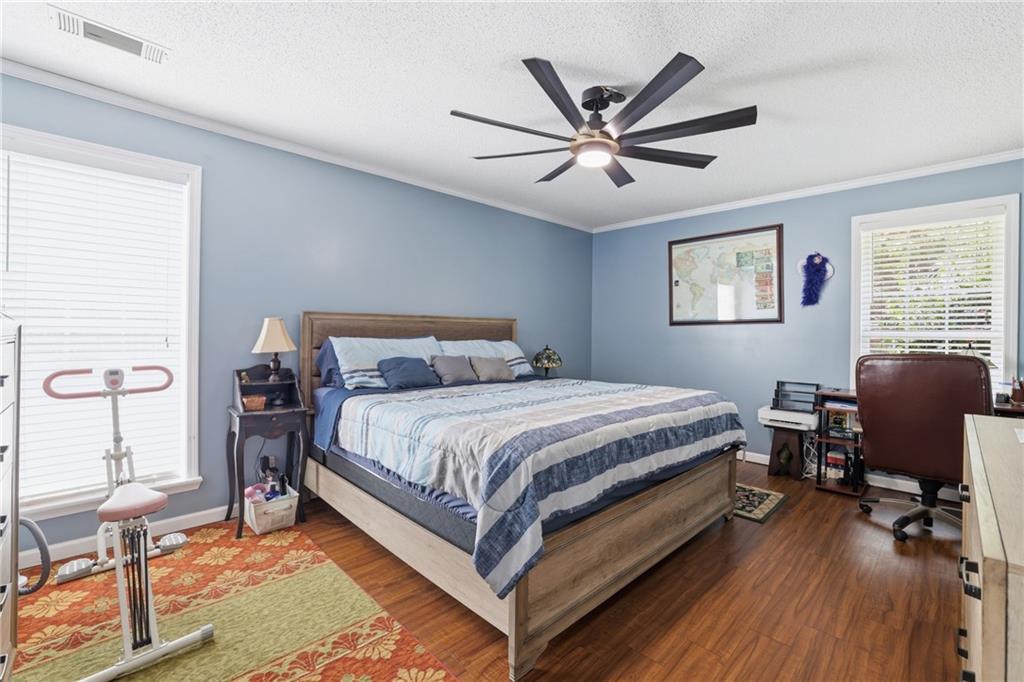 4564 Highway 51 Lula, GA 30554 - Photo 20 of 46 a bedroom with a bed a desk and chair with wooden floor