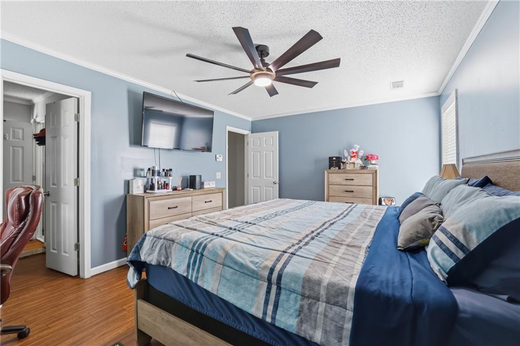 4564 Highway 51 Lula, GA 30554 - Photo 21 of 46 a bedroom with a bed and a chandelier