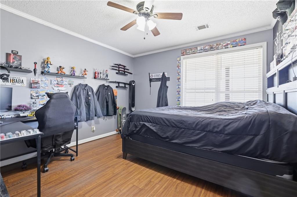 4564 Highway 51 Lula, GA 30554 - Photo 26 of 46 a bedroom with a bed and a chandelier