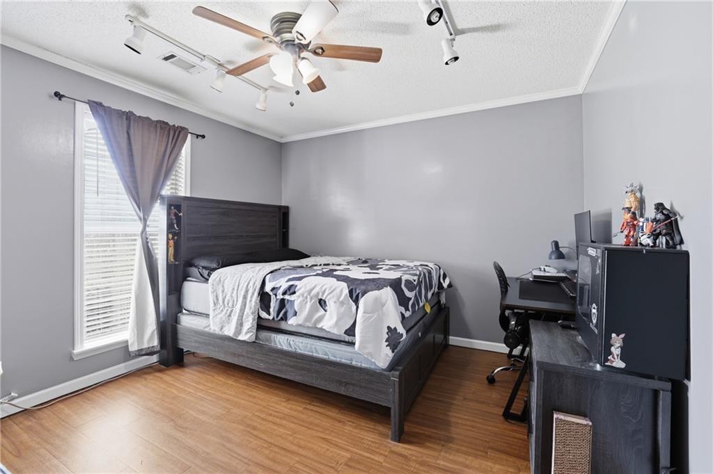 4564 Highway 51 Lula, GA 30554 - Photo 28 of 46 a bedroom with a bed and wooden floor