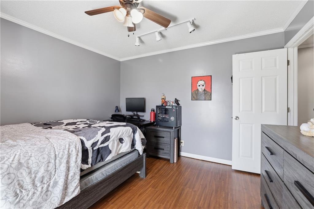 4564 Highway 51 Lula, GA 30554 - Photo 29 of 46 a bedroom with a bed and a chandelier