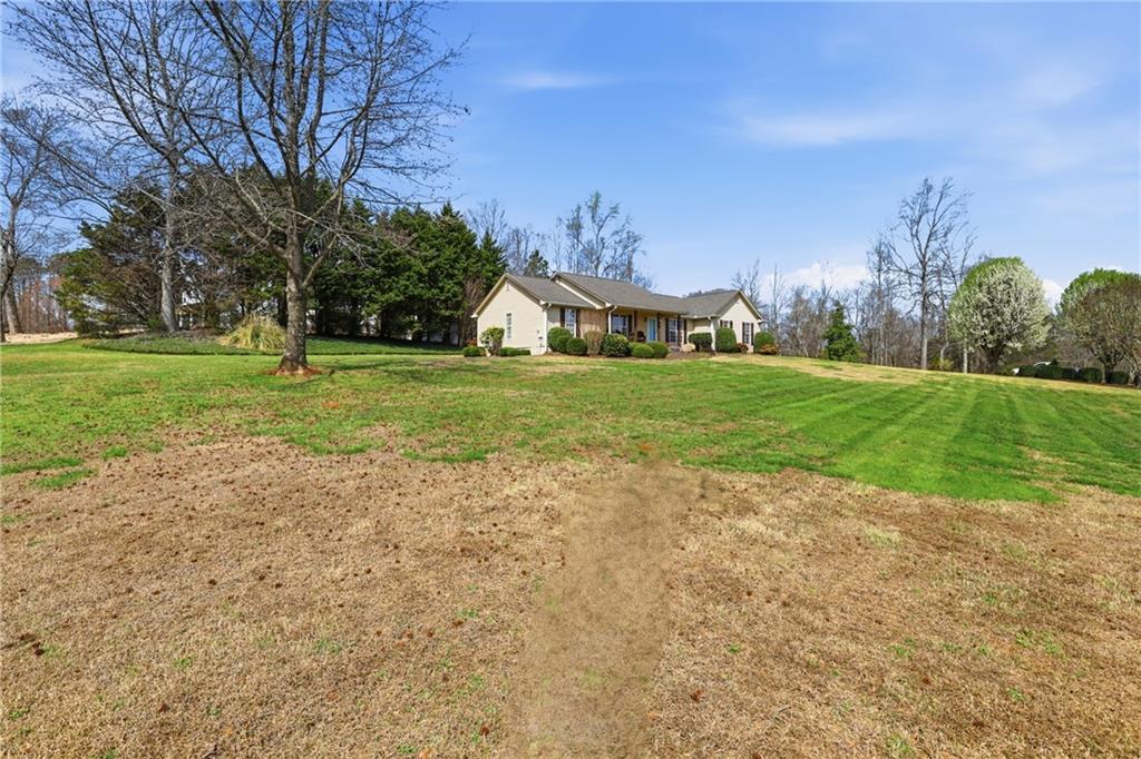 4564 Highway 51 Lula, GA 30554 - Photo 32 of 46 a front view of a house with a yard and garage