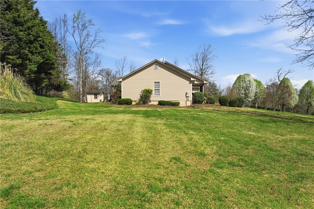4564 Highway 51 Lula, GA 30554 - Photo 34 of 46 a big house with a big yard and large trees