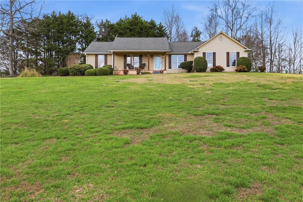 4564 Highway 51 Lula, GA 30554 - Photo 4 of 46 a front view of a house with a yard and trees