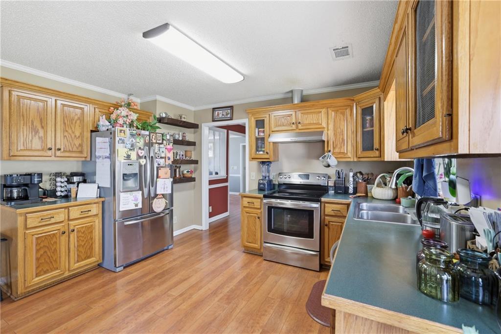 4564 Highway 51 Lula, GA 30554 - Photo 9 of 46 a kitchen with stainless steel appliances granite countertop a refrigerator stove and sink