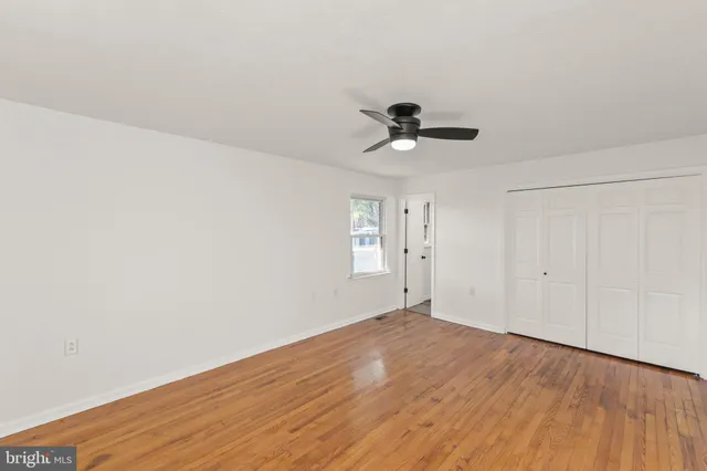 a view of an empty room and wooden floor