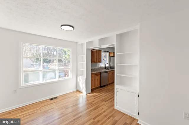 a view of kitchen with wooden floor and electronic appliances