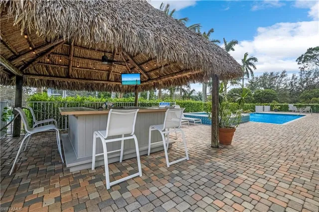 a patio with a yard table and chairs