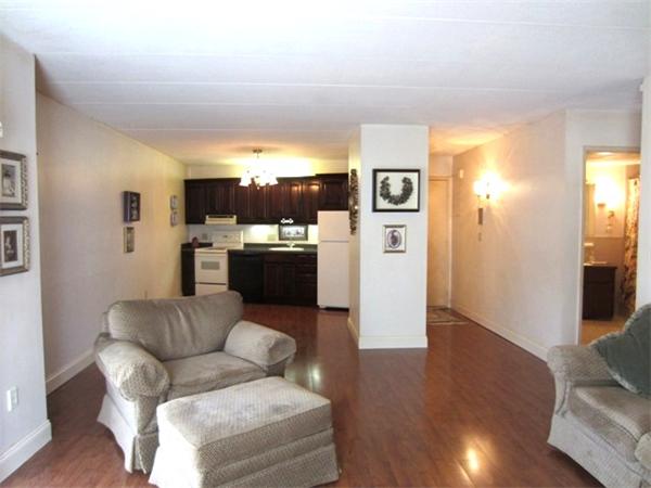 147 Turner Road, Unit 95 Holliston, MA 01746 - Photo 2 of 10 a living room with furniture and a wooden floor