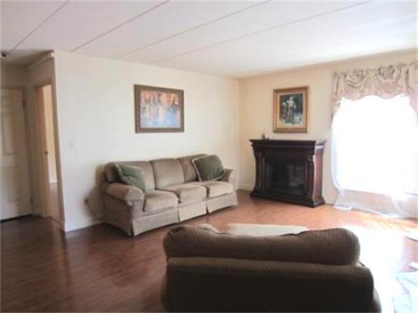 147 Turner Road, Unit 95 Holliston, MA 01746 - Photo 4 of 10 a living room with furniture and a fireplace