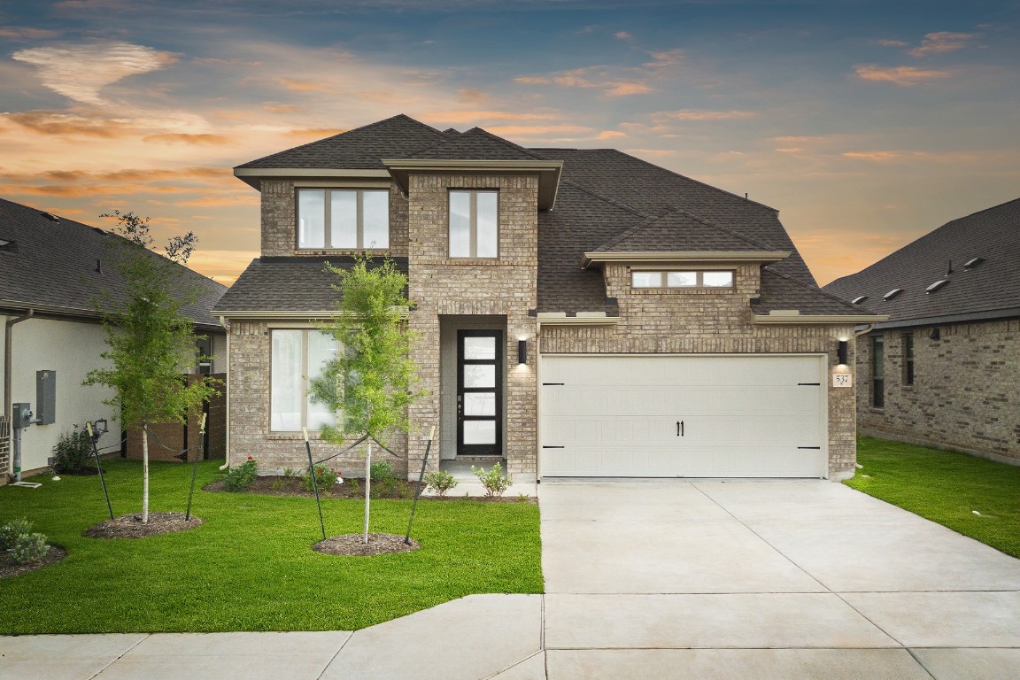 a front view of house with a garden