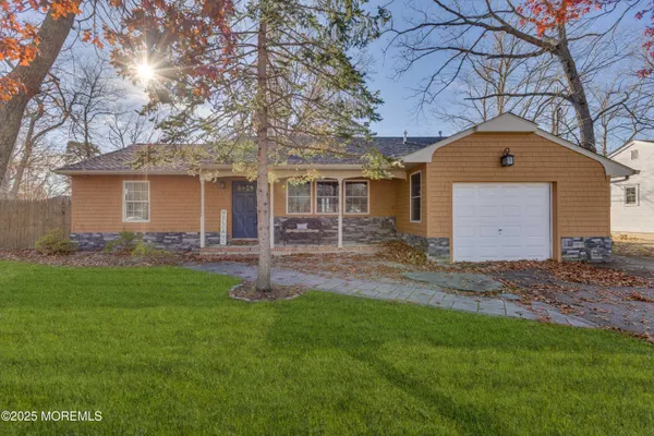 a front view of a house with a yard and porch