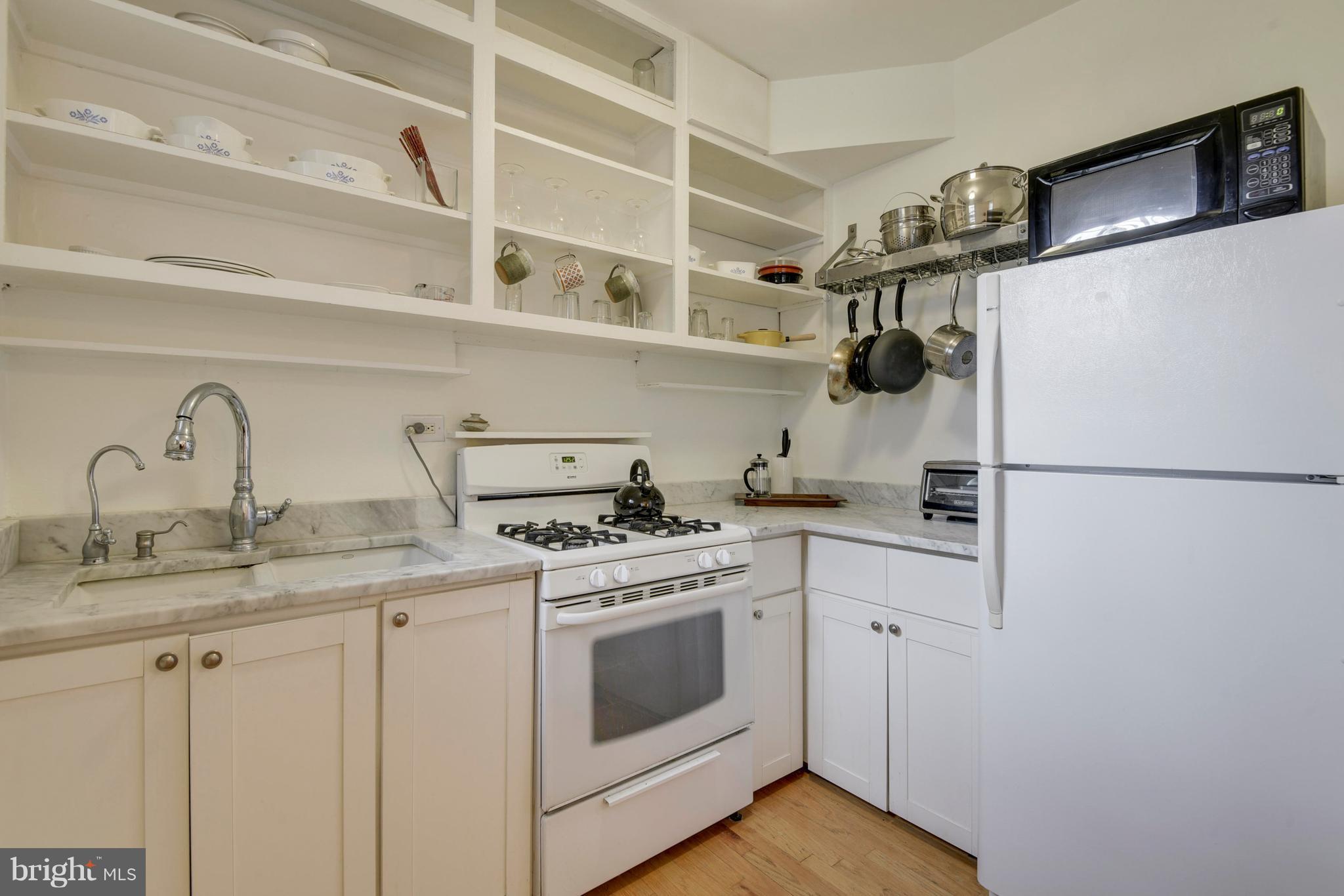 2707 Adams Mill Road Northwest, Unit 110 Washington, DC 20009 - Photo 10 of 27 Open Shelves, Full Size Gas Stove, Marble Counter
