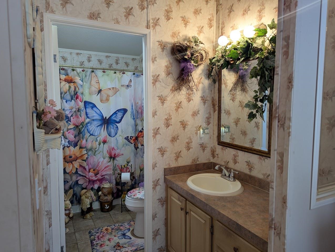 435 32 Road, Unit 405 Clifton, CO 81520 - Photo 16 of 26 a bathroom with a granite countertop sink a toilet and shower curtain