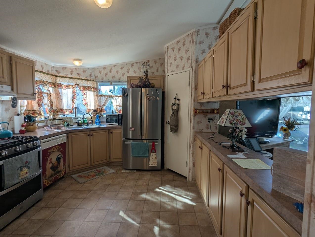 435 32 Road, Unit 405 Clifton, CO 81520 - Photo 3 of 26 a kitchen with stainless steel appliances granite countertop a refrigerator stove and sink