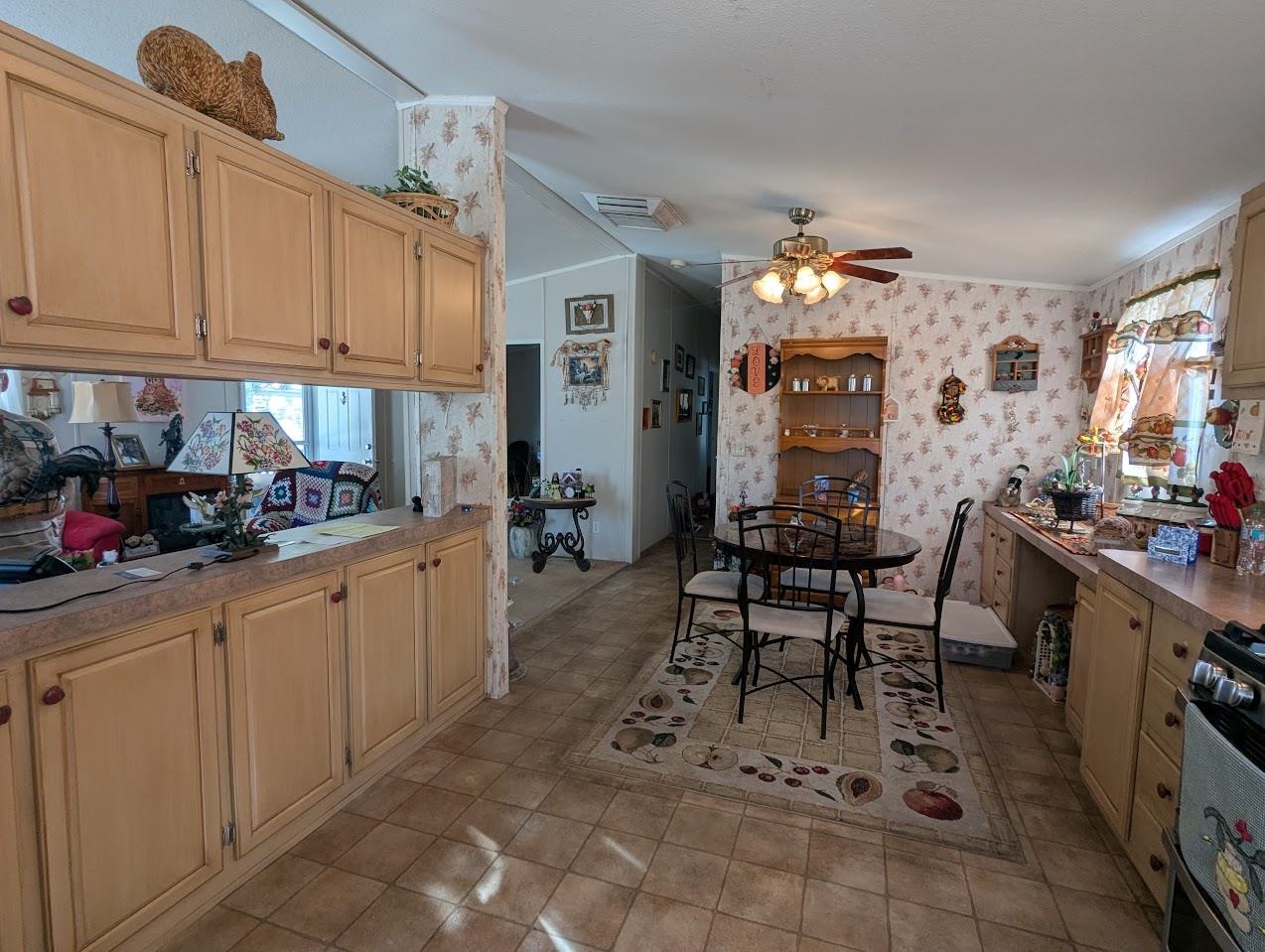 435 32 Road, Unit 405 Clifton, CO 81520 - Photo 4 of 26 a kitchen with granite countertop a table chairs stove and cabinets