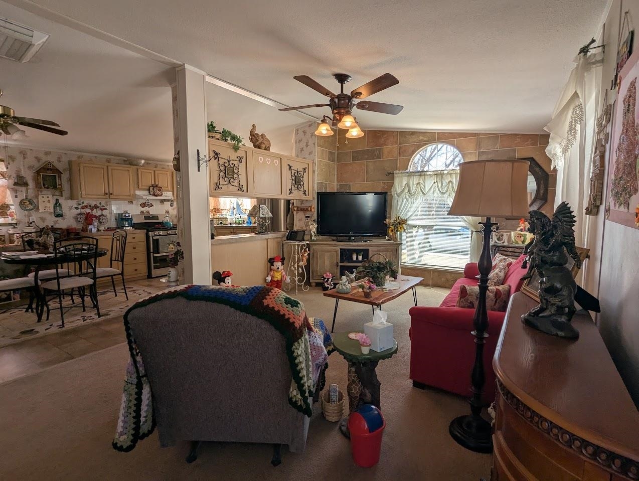 435 32 Road, Unit 405 Clifton, CO 81520 - Photo 7 of 26 a living room with furniture a flat screen tv and a fireplace