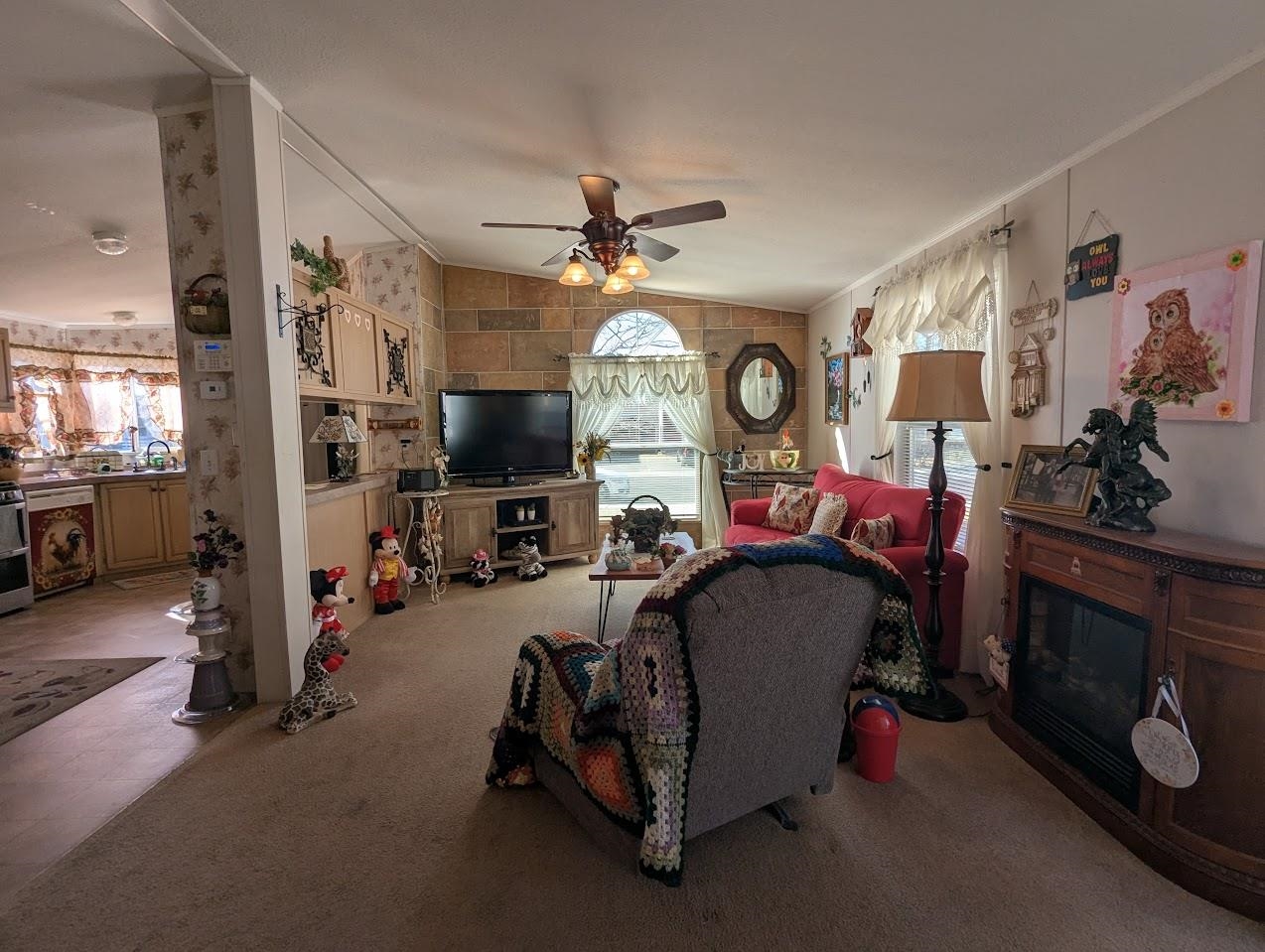 435 32 Road, Unit 405 Clifton, CO 81520 - Photo 8 of 26 a living room with furniture a flat screen tv and a fireplace