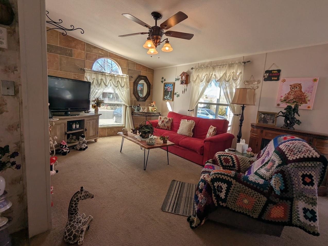 435 32 Road, Unit 405 Clifton, CO 81520 - Photo 9 of 26 a living room with furniture a flat screen tv and a window
