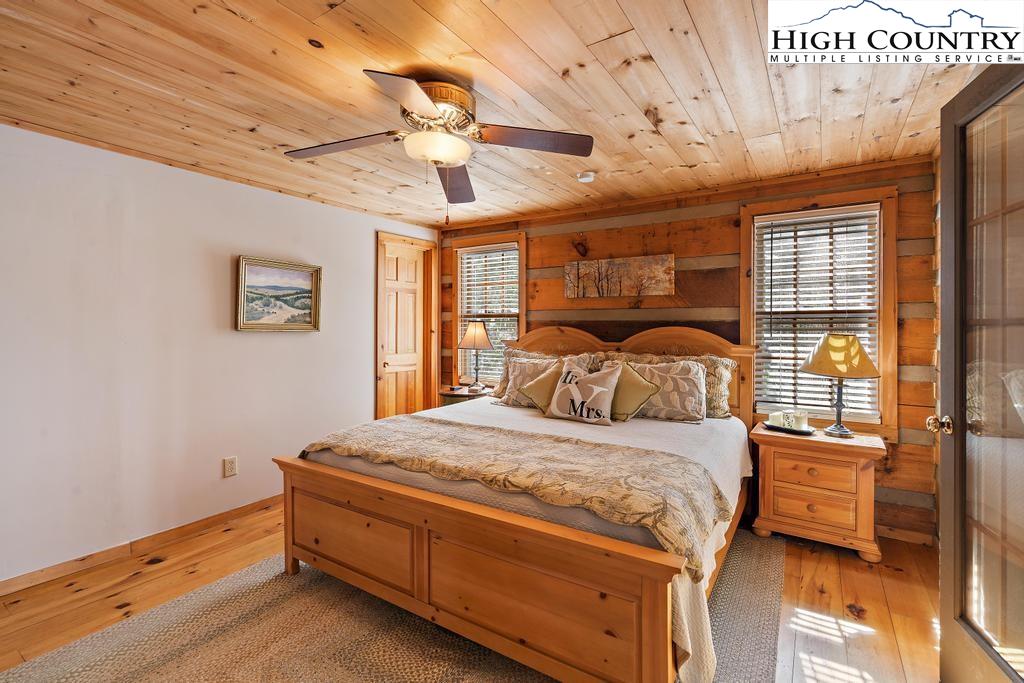 3855 Howard's Creek Road Boone, NC 28607 - Photo 21 of 38 a bedroom with a bed and wooden floor