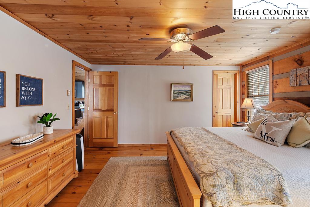 3855 Howard's Creek Road Boone, NC 28607 - Photo 22 of 38 a bedroom with a bed and wooden floor