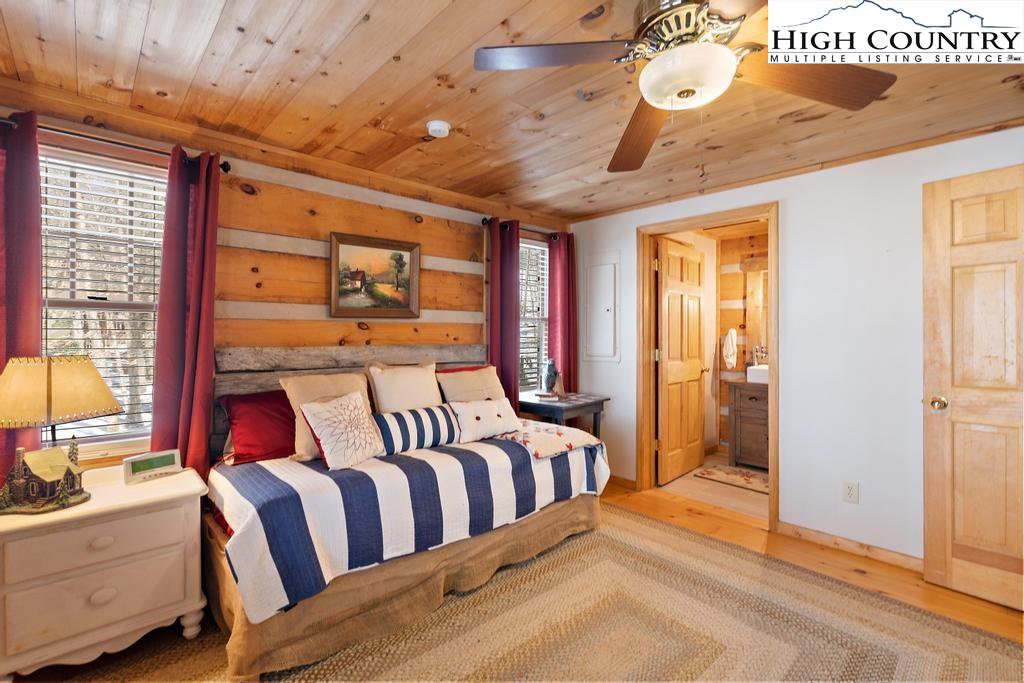 3855 Howard's Creek Road Boone, NC 28607 - Photo 26 of 38 a bedroom with a bed next to a window