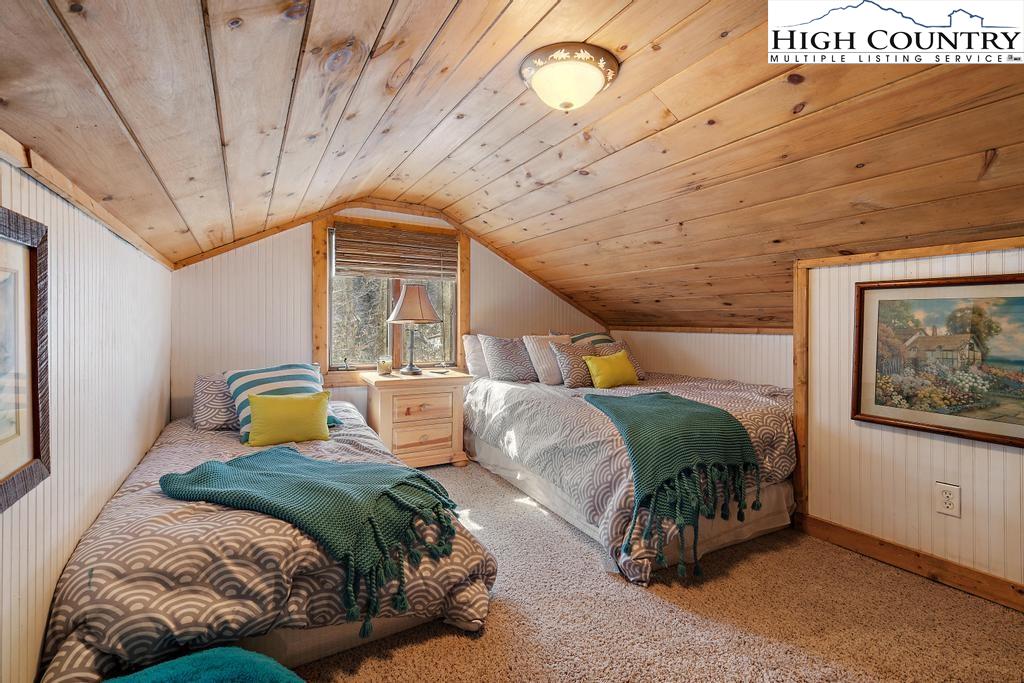 3855 Howard's Creek Road Boone, NC 28607 - Photo 30 of 38 a bedroom with a bed and wooden floor