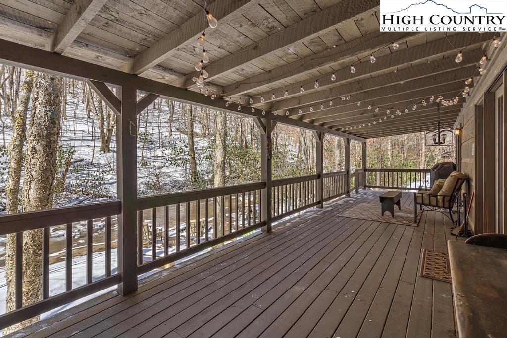3855 Howard's Creek Road Boone, NC 28607 - Photo 33 of 38 a view of a porch with wooden floor