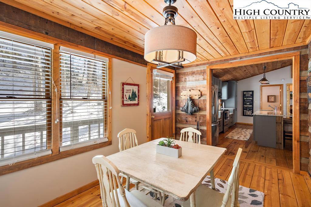 3855 Howard's Creek Road Boone, NC 28607 - Photo 8 of 38 a view of a dining room with furniture window and wooden floor
