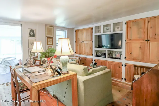 a bedroom with furniture and a large window
