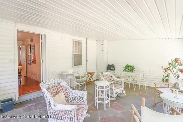 a view of a house with a tree in a yard